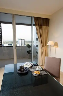 a living room with a glass table with food on it at The Apartments, Dubai World Trade Centre in Dubai