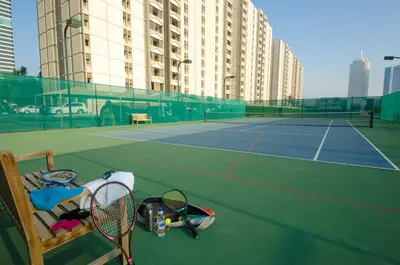 a tennis court with tennis rackets on the court at The Apartments, Dubai World Trade Centre in Dubai