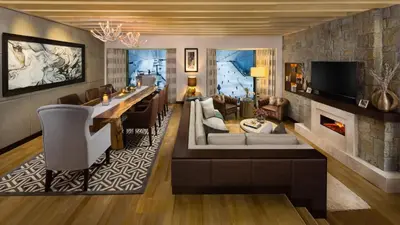 a living room with a bar and a fireplace at Aspen Chalets by Kempinski Hotel Mall of The Emirates in Dubai