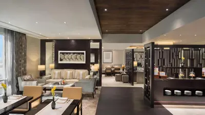 a hotel lobby with tables and chairs and a restaurant at Aspen Chalets by Kempinski Hotel Mall of The Emirates in Dubai