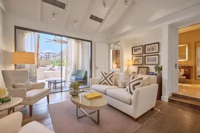 a living room with a couch and chairs and a table at Aspen Chalets by Kempinski Hotel Mall of The Emirates in Dubai