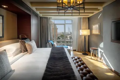 a hotel room with a large bed with a large window at Aspen Chalets by Kempinski Hotel Mall of The Emirates in Dubai