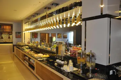 a buffet line in a restaurant with food on display at Fortune Park Hotel in Dubai