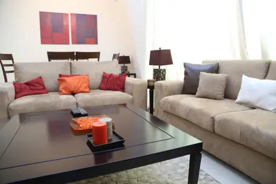 a living room with two couches and a coffee table at Armada Living - Holiday Homes Rental in Dubai