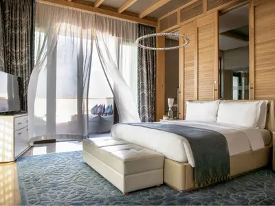 a bedroom with a large bed and a window at Jumeirah Al Naseem Dubai in Dubai