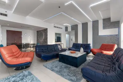a living room with couches and a table at Elan Rimal Suites in Dubai