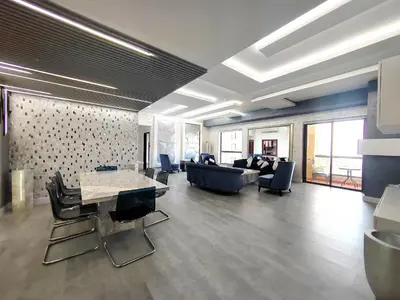 a living room with a couch and a table and chairs at Elan Rimal Suites in Dubai