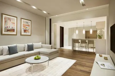 a living room with a white couch and a table at La Ville Hotel & Suites CITY WALK Dubai, Autograph Collection in Dubai