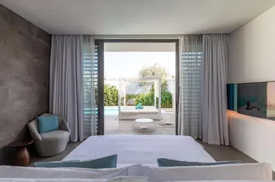 a bedroom with a large bed and a mirror at Nikki Beach Resort & Spa Dubai in Dubai