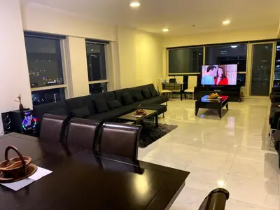 a living room with a couch and a flat screen tv at My-Places Dubai Apartment suitable for large groups Al Sahab 1 in Dubai