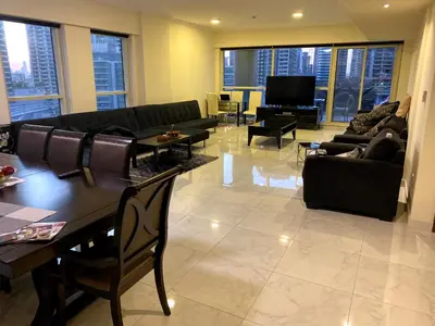 a living room with couches and tables and a television at My-Places Dubai Apartment suitable for large groups Al Sahab 1 in Dubai