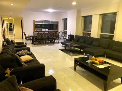 a living room with couches and a dining room at My-Places Dubai Apartment suitable for large groups Al Sahab 1 in Dubai