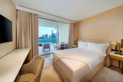 a hotel room with a bed and a desk and a television at FIVE Palm Jumeirah Dubai in Dubai