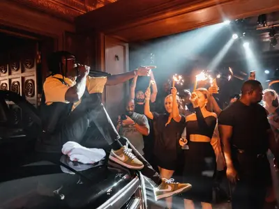 a group of people standing in a room with a dj at FIVE Palm Jumeirah Dubai in Dubai