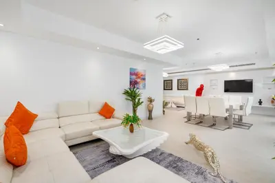 a living room with a white couch and a table at Princess Tower Dubai Marina private Spa amazing view in Dubai