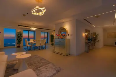 a living room with a table and a dining room at Princess Tower Dubai Marina private Spa amazing view in Dubai