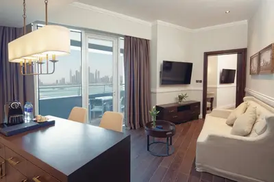 a living room with a couch and a table at Dukes The Palm Dubai Hotel in Dubai