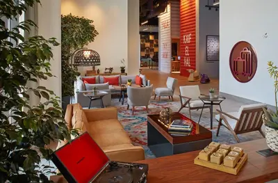 a lobby with a couch and chairs and a table at Rove Trade Centre in Dubai