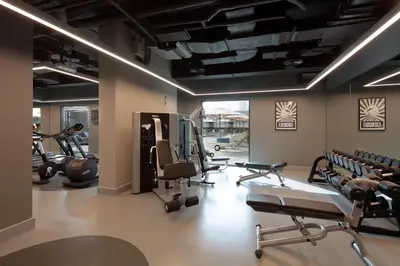 a gym with several treadmills and cardio machines at Rove Trade Centre in Dubai