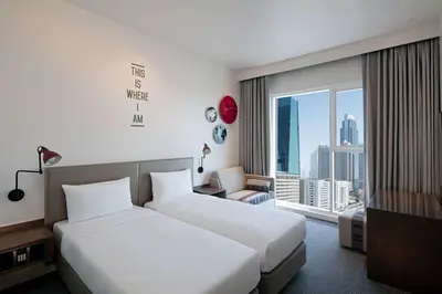 a hotel room with two beds and a window at Rove Trade Centre in Dubai