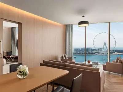 a dining room with a table and chairs and a large window at Rixos Premium Dubai JBR in Dubai