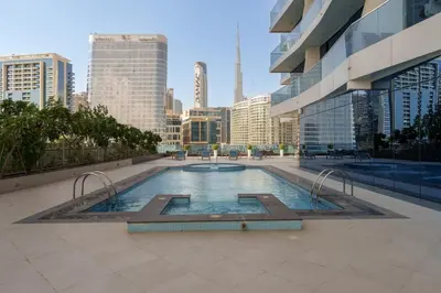 a swimming pool in the middle of a city at Maison Privee - Modern Business Bay Retreat with Dubai Canal Views in Dubai