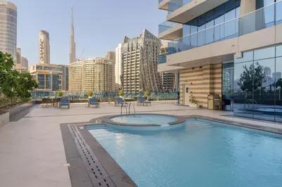 a swimming pool on the roof of a building at Maison Privee - Modern Business Bay Retreat with Dubai Canal Views in Dubai