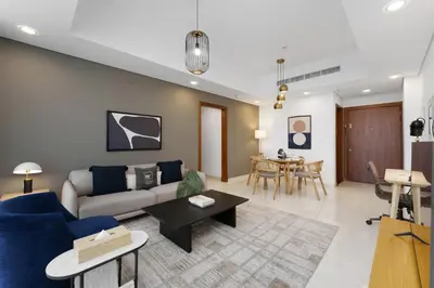 a living room with a couch and a table at Maison Privee - Modern Business Bay Retreat with Dubai Canal Views in Dubai