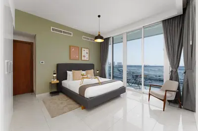 a bedroom with a bed and a view of the ocean at Maison Privee - Modern Business Bay Retreat with Dubai Canal Views in Dubai