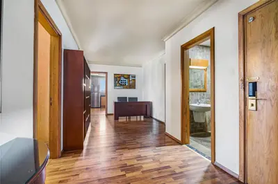 a hallway with a door and a sink in a room at Al Khoory Hotel Apartments Al Barsha in Dubai