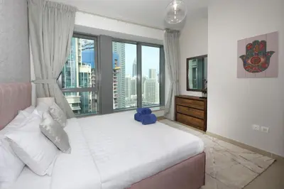 a bedroom with a large bed with a large window at New Arabian 29 Boulevard Downtown in Dubai