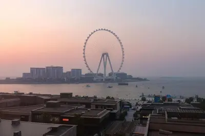 a ferris wheel in the middle of the water at Elan Rimal2 Suites in Dubai