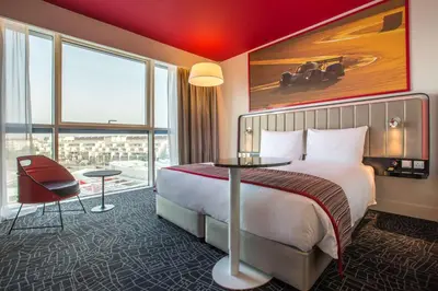 a hotel room with a bed and a large window at Park Inn by Radisson Dubai Motor City in Dubai