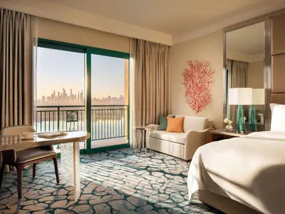 a hotel room with a bed and a couch at Atlantis, The Palm in Dubai