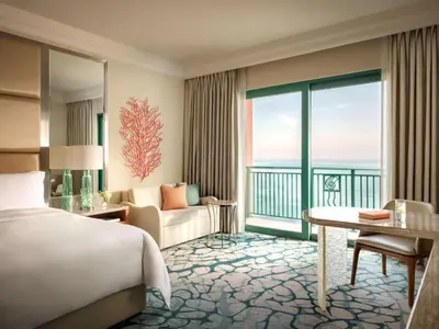 a bedroom with a bed and a room with a view at Atlantis, The Palm in Dubai