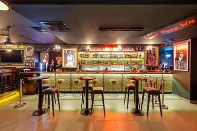 a bar with stools in front of a counter at Citymax Hotel Al Barsha at the Mall in Dubai