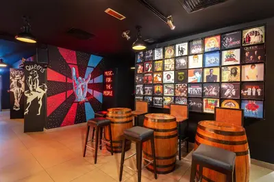 a restaurant with bar stools and posters on the wall at Citymax Hotel Al Barsha at the Mall in Dubai
