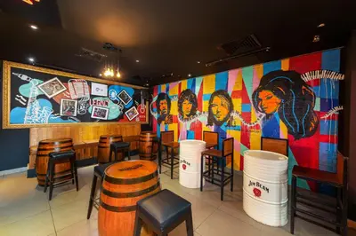 a restaurant with a bar with a large mural at Citymax Hotel Al Barsha at the Mall in Dubai