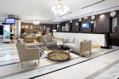 a lobby with couches and chairs and a table at Montreal Barsha Hotel in Dubai