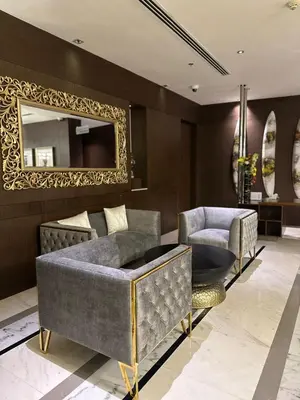 a living room with two chairs and a mirror at Montreal Barsha Hotel in Dubai