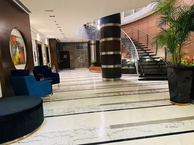 a lobby with a spiral staircase in a building at Montreal Barsha Hotel in Dubai