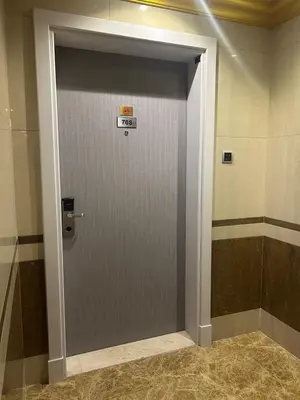 a door with a sign on it in a room at Al Raya Hotel Apartments in Dubai