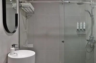 a bathroom with a shower with a toilet and a sink at Residence Inn by Marriott Sheikh Zayed Road, Dubai in Dubai