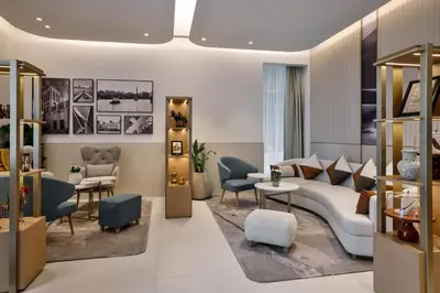 a living room with a white couch and chairs at Residence Inn by Marriott Sheikh Zayed Road, Dubai in Dubai