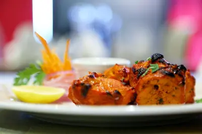 a plate of food with a lemon on a table at Baity Hotel Apartments in Dubai