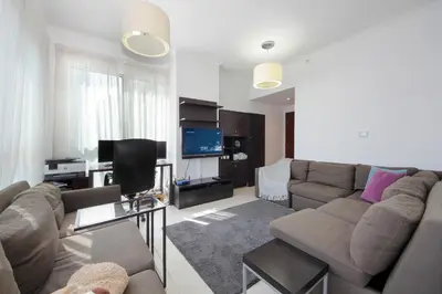 a living room with a couch and a tv at New Arabian Burj Residence 1 & 8 Downtown Dubai in Dubai