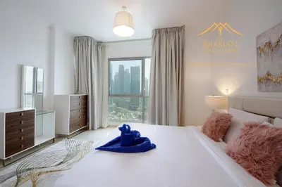 a bedroom with a large bed with a blue toy on it at New Arabian Burj Residence 1 & 8 Downtown Dubai in Dubai