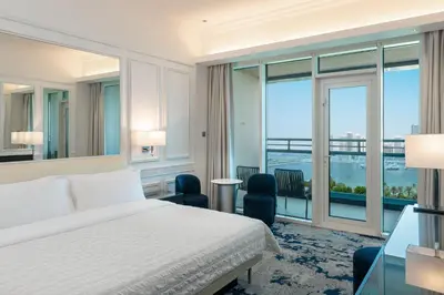 a bedroom with a bed and a large window at Le Meridien Mina Seyahi Beach Resort & Waterpark in Dubai