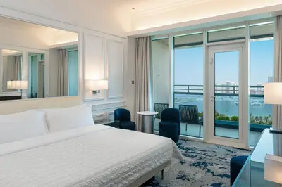 a hotel room with a bed and a large window at Le Meridien Mina Seyahi Beach Resort & Waterpark in Dubai