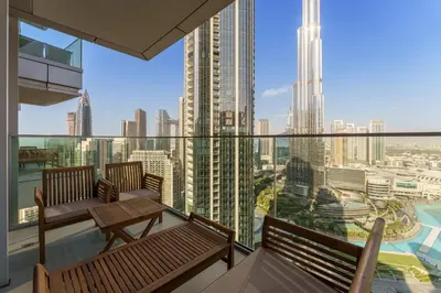 a balcony with two benches and a view of the city at Maison Privee - Ultimate Living with Front-Row Views of Burj Khalifa & Dubai Fountains in Dubai